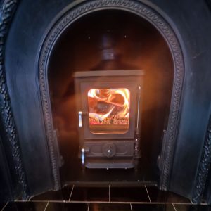 Compact Hobbit stove in traditional Victorian fireplace Compact Hobbit stove in traditional Victorian fireplace